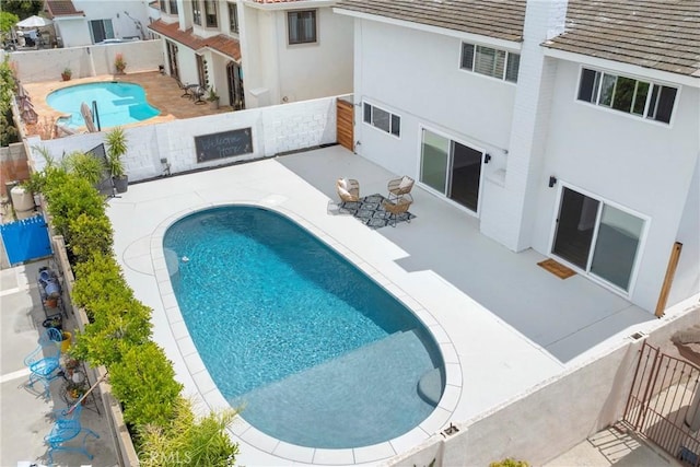 view of pool featuring a patio area and a fenced backyard