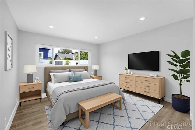 bedroom with light wood finished floors, baseboards, and recessed lighting