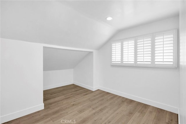 bonus room with vaulted ceiling, baseboards, wood finished floors, and recessed lighting