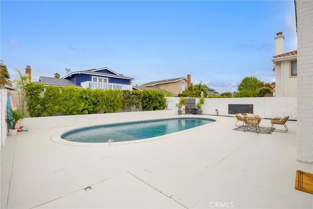 view of pool featuring a patio and a fenced backyard