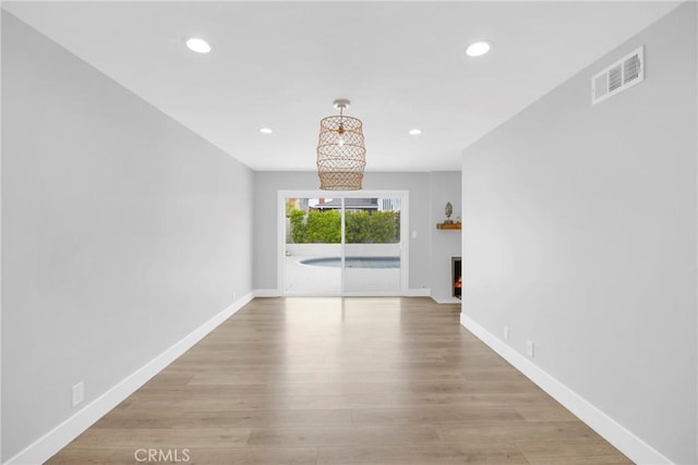 unfurnished living room featuring recessed lighting, baseboards, and wood finished floors