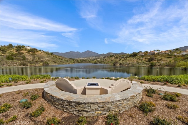 exterior space with a fenced backyard and a water and mountain view