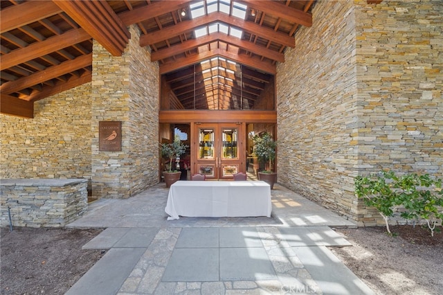 doorway to property with stone siding and french doors