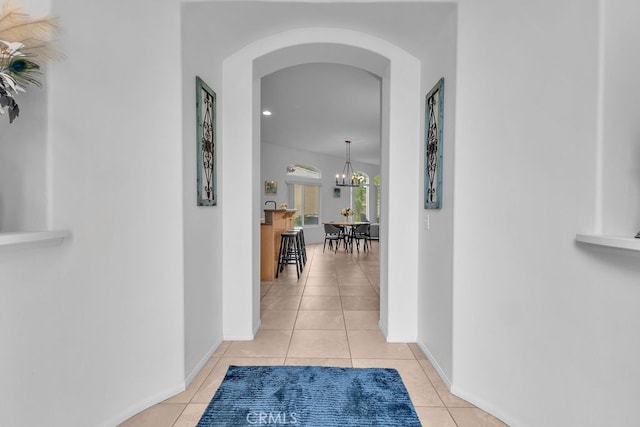 82689 Odlum Dr, Indio, CA 92201 - hall featuring arched walkways, baseboards, an inviting chandelier, and light tile patterned floors