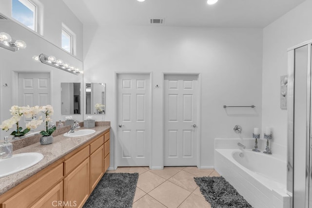 82689 Odlum Dr, Indio, CA 92201 - full bath featuring tile patterned floors, a garden tub, visible vents, and a sink