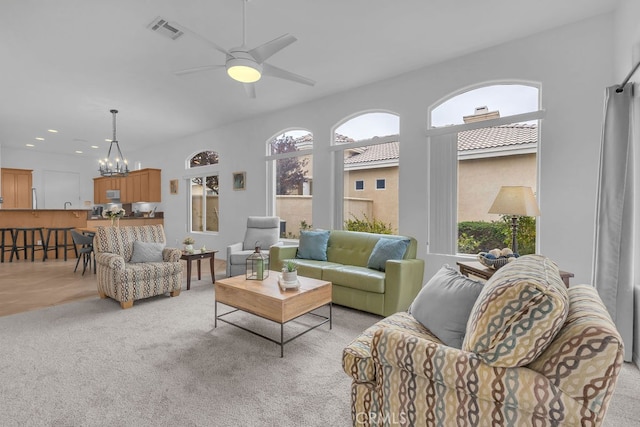 82689 Odlum Dr, Indio, CA 92201 - living area featuring light colored carpet, visible vents, and plenty of natural light