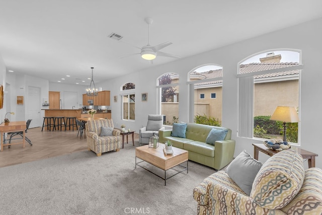 82689 Odlum Dr, Indio, CA 92201 - living room with light colored carpet, ceiling fan with notable chandelier, visible vents, and recessed lighting