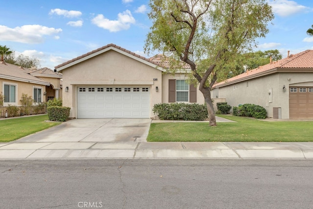 82689 Odlum Dr, Indio, CA 92201 - view of front of house featuring an attached garage, stucco siding, driveway, and a front yard