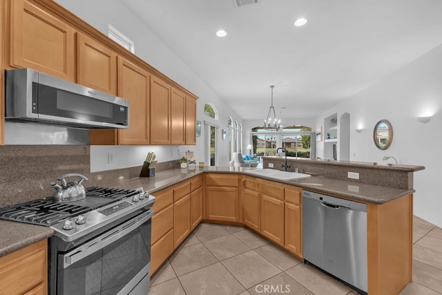 82689 Odlum Dr, Indio, CA 92201 - kitchen featuring a sink, a peninsula, stainless steel appliances, a chandelier, and light tile patterned floors