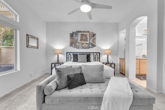 82689 Odlum Dr, Indio, CA 92201 - bedroom featuring connected bathroom, baseboards, arched walkways, and carpet floors