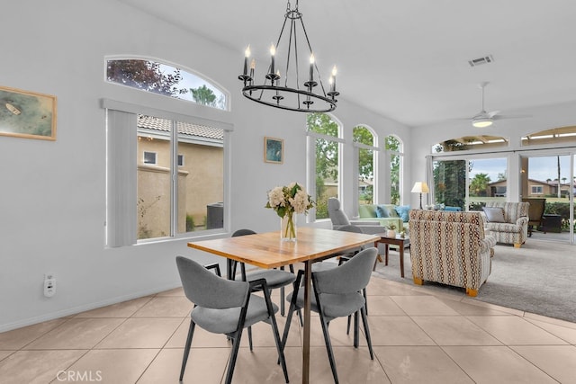 82689 Odlum Dr, Indio, CA 92201 - dining area with vaulted ceiling, light tile patterned floors, visible vents, and ceiling fan with notable chandelier