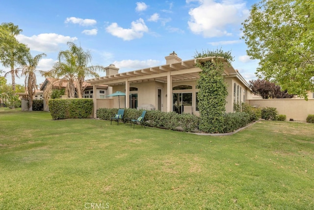 82689 Odlum Dr, Indio, CA 92201 - back of property featuring a chimney, a yard, stucco siding, and fence
