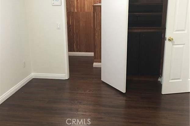 3545 20th St, Highland, CA 92346 - hallway with baseboards and wood finished floors