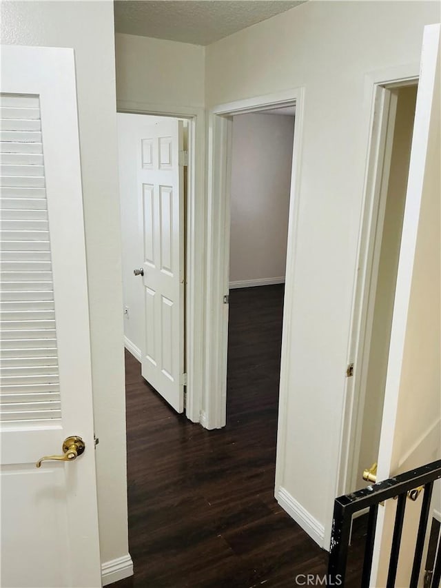 3545 20th St, Highland, CA 92346 - hallway featuring dark wood finished floors and baseboards