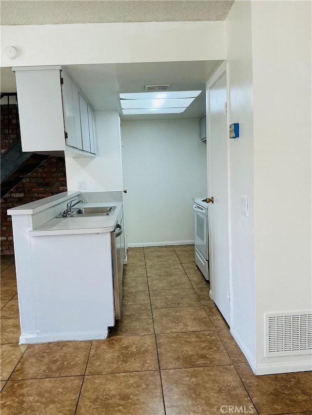 3545 20th St, Highland, CA 92346 - kitchen with electric stove, light countertops, a sink, tile patterned floors, and baseboards