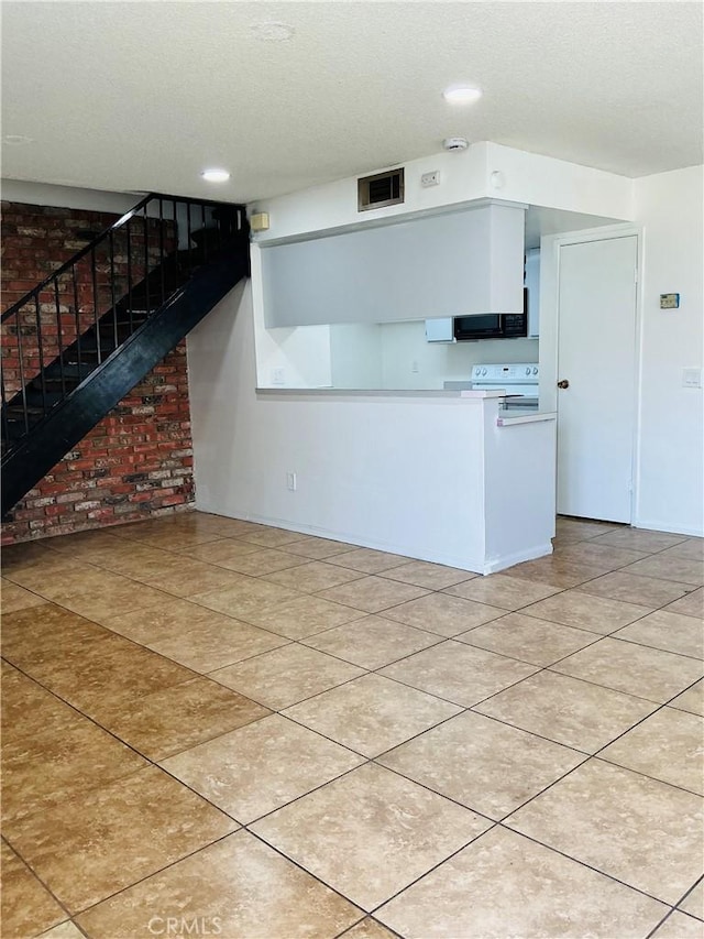 3545 20th St, Highland, CA 92346 - kitchen with white electric range oven, a textured ceiling, recessed lighting, black microwave, and light tile patterned flooring