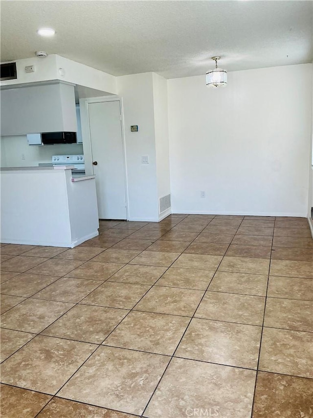 3545 20th St, Highland, CA 92346 - kitchen with white range with electric stovetop, a textured ceiling, light tile patterned floors, light countertops, and baseboards