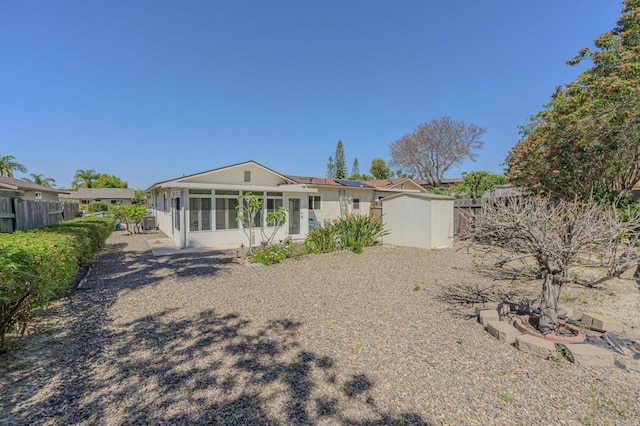 1398 Panorama Ridge Rd, Oceanside, CA 92056 - back of house with a sunroom, a fenced backyard, and a storage unit