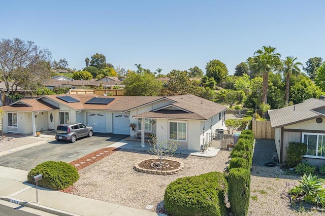 1398 Panorama Ridge Rd, Oceanside, CA 92056 - single story home featuring driveway, an attached garage, and roof mounted solar panels