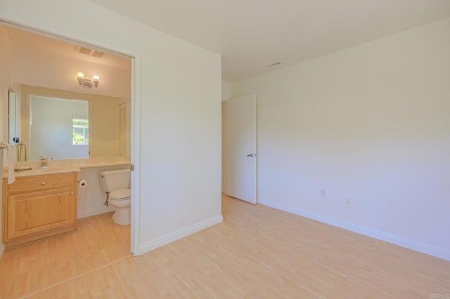 1398 Panorama Ridge Rd, Oceanside, CA 92056 - unfurnished bedroom featuring light wood-style flooring, ensuite bathroom, and a desk
