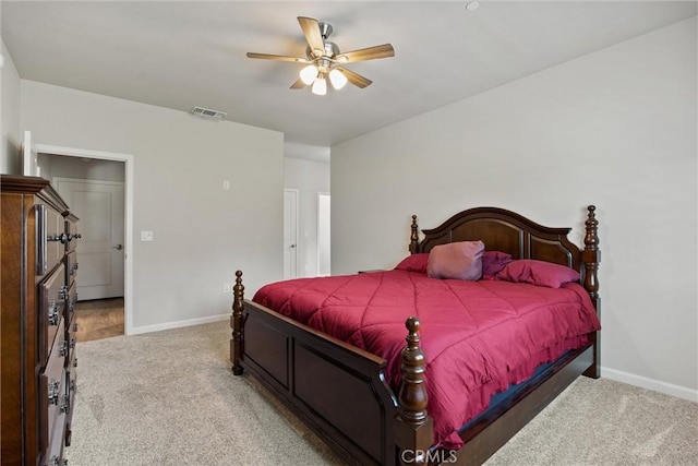 bedroom featuring light colored carpet, baseboards, a ceiling fan, and visible vents