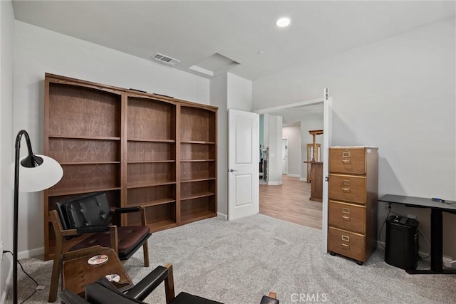 living area with carpet floors, visible vents, and baseboards
