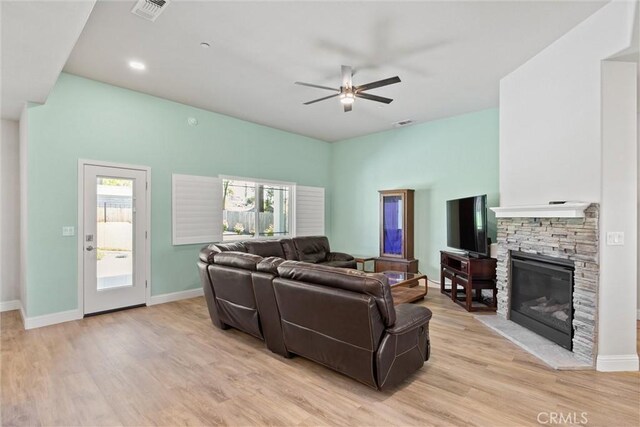 6294 W Wagstaff Rd, Paradise, CA 95969 - living area featuring a ceiling fan, light wood-style floors, a stone fireplace, baseboards, and recessed lighting