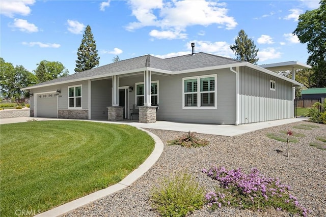 view of front of home with a garage, a front lawn, concrete driveway, and fence
