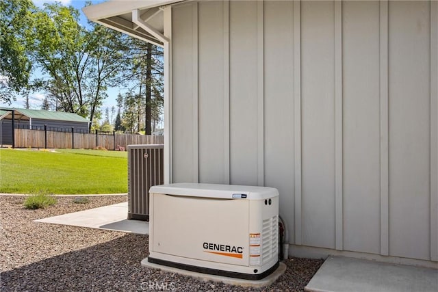exterior details featuring board and batten siding, central AC, a power unit, and fence