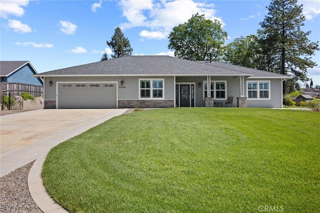 ranch-style home featuring an attached garage, a front lawn, driveway, and stone siding