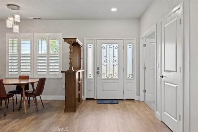 foyer entrance with recessed lighting, baseboards, visible vents, and light wood-style flooring