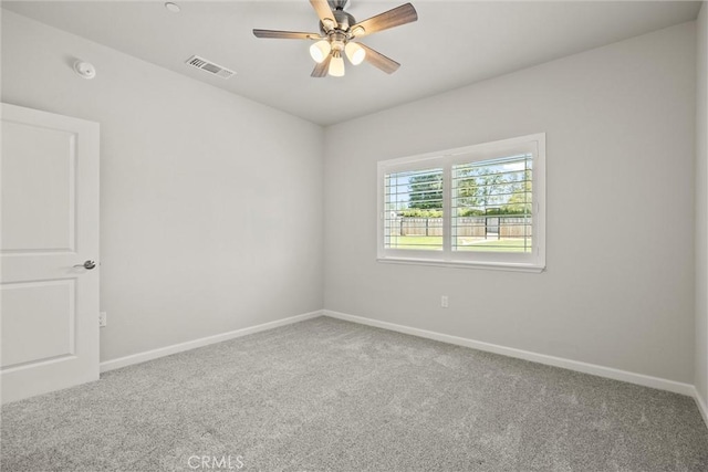empty room featuring baseboards, carpet flooring, and visible vents