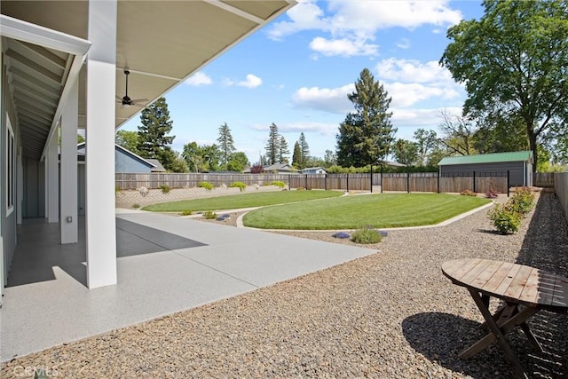 view of yard with a fenced backyard, a ceiling fan, and a patio