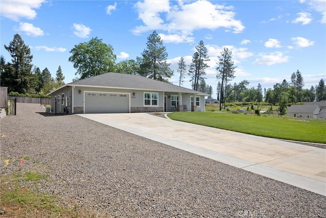 single story home featuring a garage, driveway, stone siding, fence, and a front yard