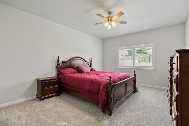 bedroom featuring light carpet, baseboards, and ceiling fan