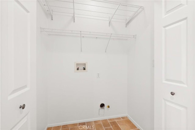 clothes washing area with hookup for a gas dryer, baseboards, and washer hookup