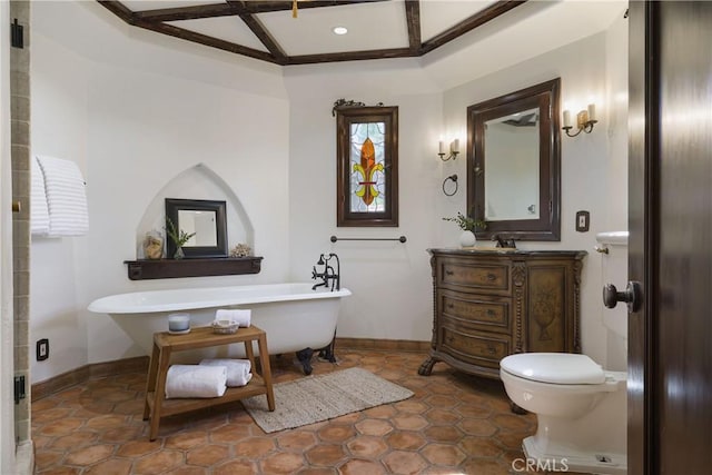 full bathroom featuring toilet, baseboards, coffered ceiling, a freestanding tub, and vanity