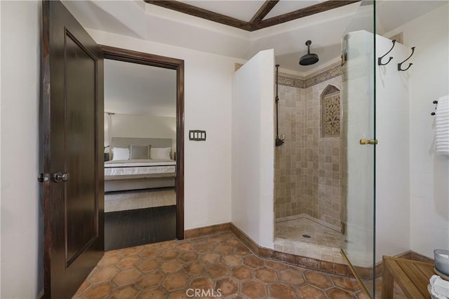 ensuite bathroom featuring baseboards, connected bathroom, and a stall shower