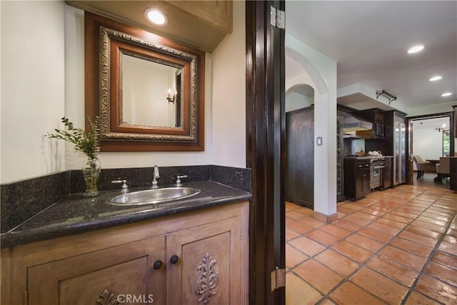 bathroom with recessed lighting, tile patterned flooring, and vanity