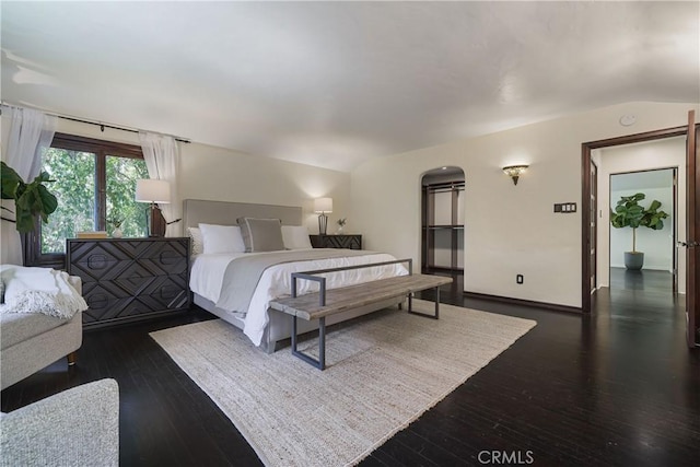 bedroom featuring vaulted ceiling and hardwood / wood-style flooring