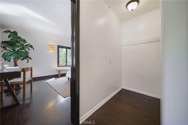hallway with baseboards and wood finished floors
