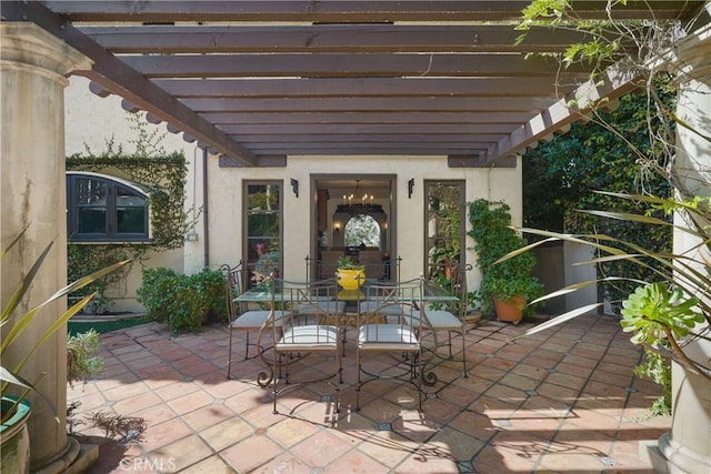 view of patio featuring a pergola and outdoor dining space