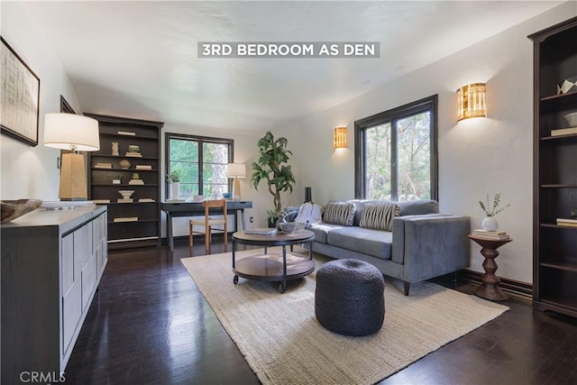 living area with dark wood finished floors and built in features