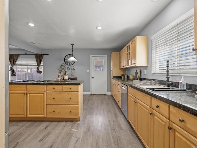kitchen with plenty of natural light, dishwasher, a sink, and light wood-style floors