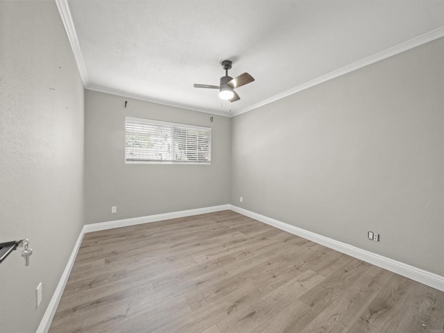 empty room featuring ceiling fan, baseboards, wood finished floors, and ornamental molding