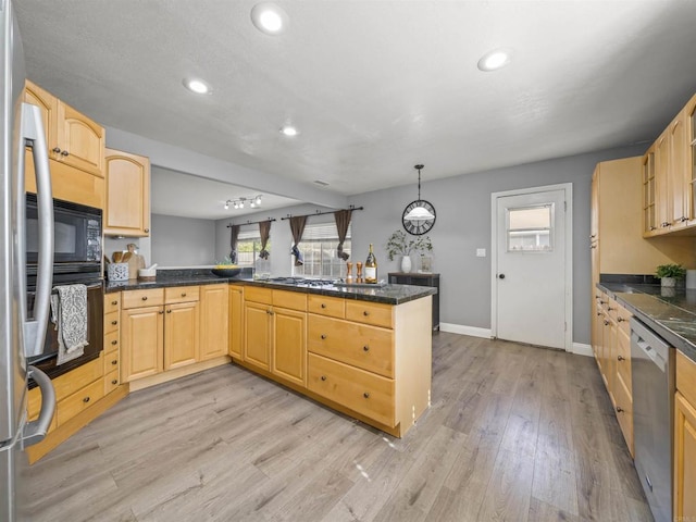 kitchen with stainless steel appliances, a peninsula, baseboards, and dark countertops