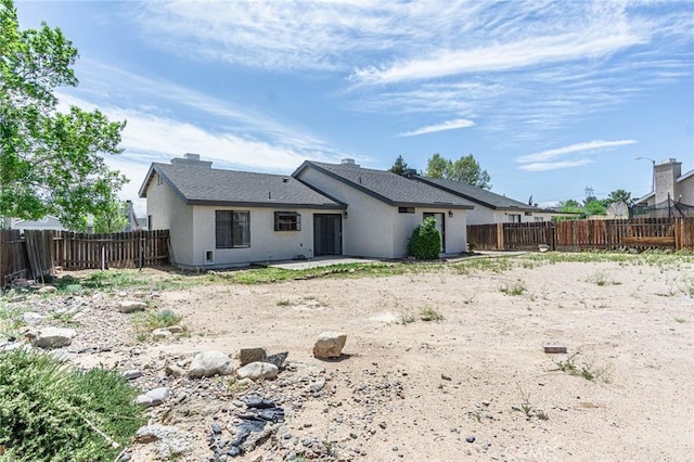 14292 Pinewood Dr, Hesperia, CA 92344 - back of house featuring a patio area, a fenced backyard, roof with shingles, and stucco siding