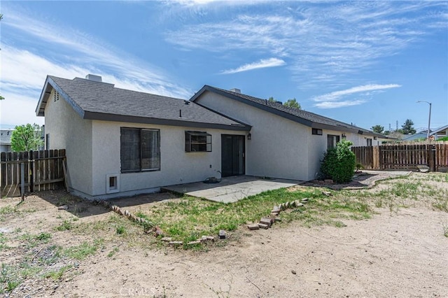 14292 Pinewood Dr, Hesperia, CA 92344 - back of house with stucco siding, a fenced backyard, and a patio