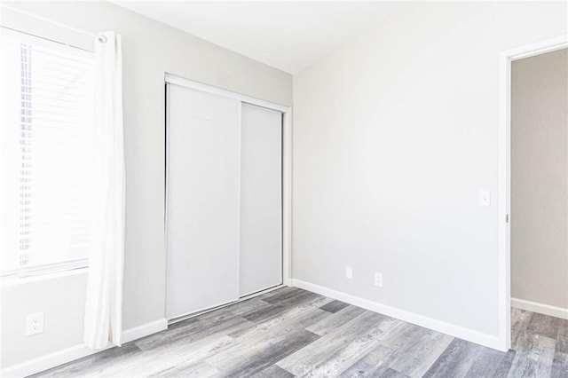 14292 Pinewood Dr, Hesperia, CA 92344 - unfurnished bedroom with wood finished floors, a closet, and baseboards