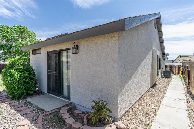 14292 Pinewood Dr, Hesperia, CA 92344 - exterior space featuring stucco siding, fence, and central AC
